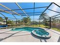 Relaxing screened pool and spa overlooking the canal at 608 69Th W Ave, Bradenton, FL 34207