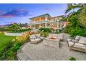 Relaxing fire pit area with comfortable seating, overlooking the bay at 641 Key Royale Dr, Holmes Beach, FL 34217