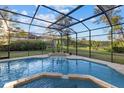 Inviting screened pool offers a relaxing retreat with lush greenery and scenic views in the backyard at 6779 Ashley Ct, Sarasota, FL 34241