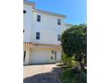 Inviting three-story townhome with a charming Spanish-style roof and lush landscaping at 9923 Manatee W Ave # 4, Bradenton, FL 34209