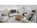 Spacious living room with contemporary furnishings and large windows at 12939 Seasong Ter, Bradenton, FL 34211