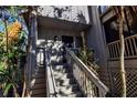 Gray house with stairs leading to the entrance, surrounded by tropical plants at 1460 Landings Cir # 51, Sarasota, FL 34231
