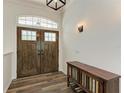 Elegant entryway with double doors and wood console table at 21709 Deer Pointe Xing, Bradenton, FL 34202