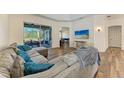 Spacious living room with L-shaped sectional sofa and wood floors at 21709 Deer Pointe Xing, Bradenton, FL 34202