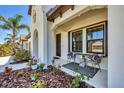 Inviting front porch with seating and landscaping welcomes you to this lovely home at 249 Palmaria Ct, Nokomis, FL 34275
