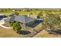 Expansive home features a backyard tiki bar, mature trees, and perimeter fencing on a large lot at 25205 67Th E Ave, Myakka City, FL 34251