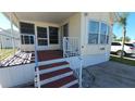 Inviting front porch with sturdy railings and easy access, adding curb appeal to the manufactured home at 3333 26Th E Ave # 1195, Bradenton, FL 34208