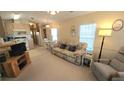 Open living room with a sofa, recliner and view of kitchen at 3333 26Th E Ave # 1195, Bradenton, FL 34208