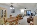 Bright dining room with table and chairs, adjacent to living room at 3634 Lake Bayshore Dr # 308, Bradenton, FL 34205