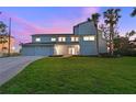 Renovated waterfront home with a two-car garage and manicured lawn at 3804 Bayside Dr, Bradenton, FL 34210