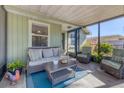 Relaxing screened porch with wicker furniture and tile floor at 3931 Longhorn Dr, Sarasota, FL 34233