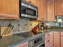 Modern kitchen with stainless steel appliances and tile backsplash at 4002 Wilshire E Cir # 90, Sarasota, FL 34238