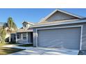 Two-story house with gray siding, a two-car garage, and a porch at 4042 Kingsfield Dr, Parrish, FL 34219