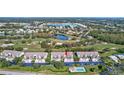 Aerial view of condo building near pool and golf course at 6713 Stone River Rd # 205, Bradenton, FL 34203