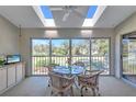 Bright sunroom features skylights, large windows with golf course view, and a comfortable seating area at 6713 Stone River Rd # 205, Bradenton, FL 34203