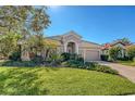 One-story house with a brick driveway and lush landscaping at 6836 Bay Hill Dr, Bradenton, FL 34202