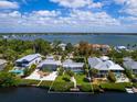 Aerial view showcasing a single-Gathering home with a pool and private dock at 7916 Midnight Pass Rd, Sarasota, FL 34242