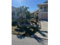 Landscaped front yard with tropical plants and a stone driveway at 109 Tortuga Dr, Nokomis, FL 34275