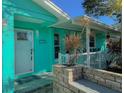 Inviting front entrance with a teal exterior and white door at 10965 117Th St, Largo, FL 33778