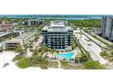 Aerial view of a condo building with pool, offering beach and water views at 1102 Benjamin Franklin Dr # 407, Sarasota, FL 34236