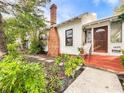 White house with brick chimney, lush landscaping, and a walkway to the front door at 1420 22Nd W St, Bradenton, FL 34205