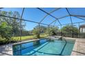 Inviting screened-in pool with spa, surrounded by a paved patio at 17923 Polo Trl, Bradenton, FL 34211
