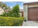 Neat landscaping leads to a brown double-door garage at 2917 Park Lake Dr # 2917, Bradenton, FL 34209