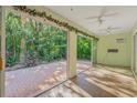 Relaxing Florida room with sliding glass doors opening to a brick patio at 3614 E 62Nd Ave, Bradenton, FL 34203
