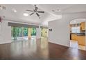 Bright living room featuring sliding doors to a patio, hardwood floors, and a kitchen at 3614 E 62Nd Ave, Bradenton, FL 34203
