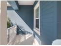 Small side porch with white railing and blue exterior at 3632 Shimmering Oaks Dr, Parrish, FL 34219