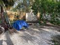 Backyard with shed, gravel area, and some yard debris at 648 Calle De Peru, Sarasota, FL 34242