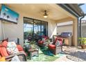 Relaxing covered patio with outdoor kitchen and comfortable seating at 6517 Willowshire Way, Bradenton, FL 34212