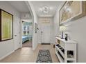 Bright and airy entryway with a white console table and tile flooring at 7573 Mikasa Dr, Punta Gorda, FL 33950