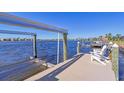 Private dock with boat lift and seating area, offering waterfront access at 1014 Overlook Ct, Bradenton, FL 34208