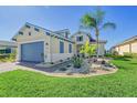 Charming one-story house with blue garage door and nicely landscaped yard at 1014 Overlook Ct, Bradenton, FL 34208