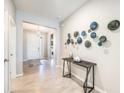 Bright foyer with tile floors and modern wall art at 12689 Promenade Estates Blvd, Sarasota, FL 34238