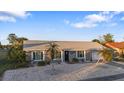 Front view of a single-story house with palm trees at 13368 Englewood Rd, Port Charlotte, FL 33981