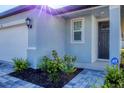 House entrance with gray door and ADT security system at 148 Whiteland Bnd, Nokomis, FL 34275