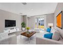 Bright living room with white couch, coffee table, and large TV at 148 Whiteland Bnd, Nokomis, FL 34275