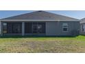 House with screened porch and grassy backyard at 16128 67Th E Ct, Parrish, FL 34219