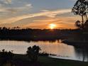 Stunning sunset over a tranquil lake at 20833 Cattail Blvd, Venice, FL 34292