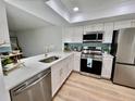 Updated kitchen featuring white cabinets, stainless steel appliances, and quartz countertops at 3504 Beneva Rd # 206, Sarasota, FL 34239