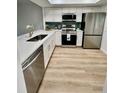 Updated kitchen featuring white cabinets, stainless steel appliances, and quartz countertops at 3504 Beneva Rd # 206, Sarasota, FL 34239