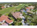 Luxury home on golf course, with tile roof and lush landscaping at 4211 Palacio Dr, Sarasota, FL 34238