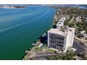 A scenic aerial view of the waterfront condo building with a private pool and dock at 4822 Ocean Blvd # 10E, Sarasota, FL 34242