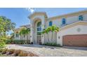 Elegant two-story waterfront home with a grand entrance and a tiled driveway at 510 Bowsprit Ln, Longboat Key, FL 34228