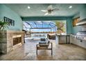 Outdoor kitchen with fireplace,water views, and stainless steel appliances at 5403 Tidewater Preserve Blvd, Bradenton, FL 34208