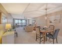 Bright dining area with table and chairs, open to living room at 5911 Midnight Pass Rd # 504, Sarasota, FL 34242
