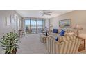 Living room with water views, comfy seating, and balcony access at 5911 Midnight Pass Rd # 504, Sarasota, FL 34242