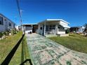 Mobile home with driveway and grassy area at 615 50Th Avenue W Ter, Bradenton, FL 34207